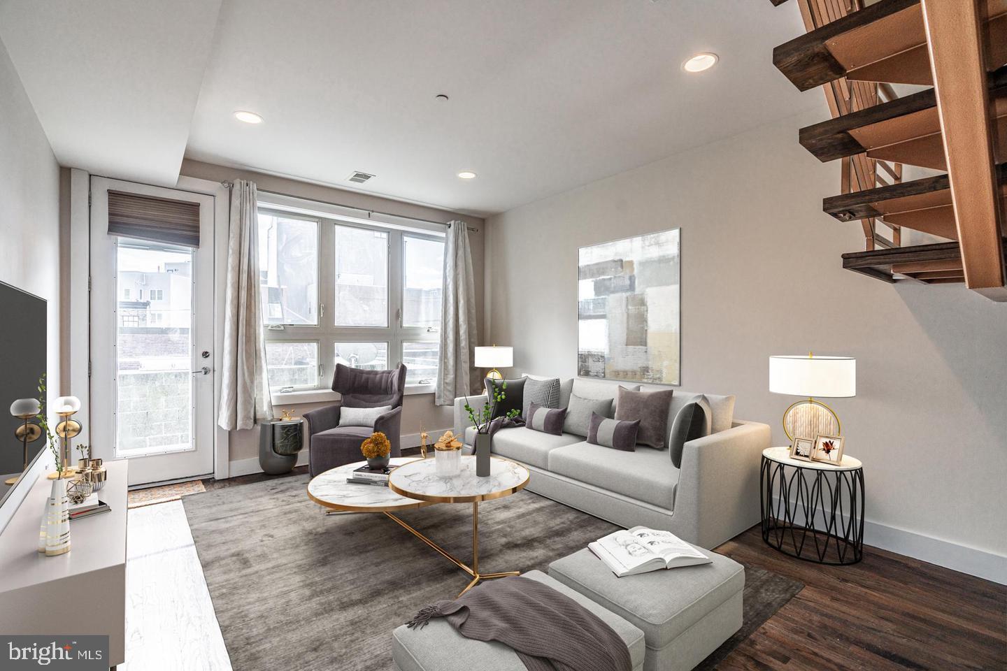 a living room with furniture and floor to ceiling windows