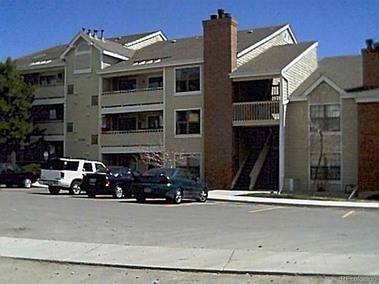 a front view of a house with a road