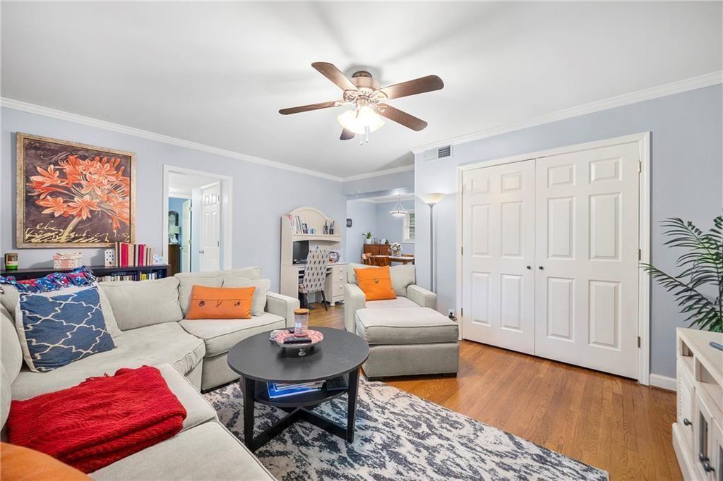 a living room with furniture and wooden floor