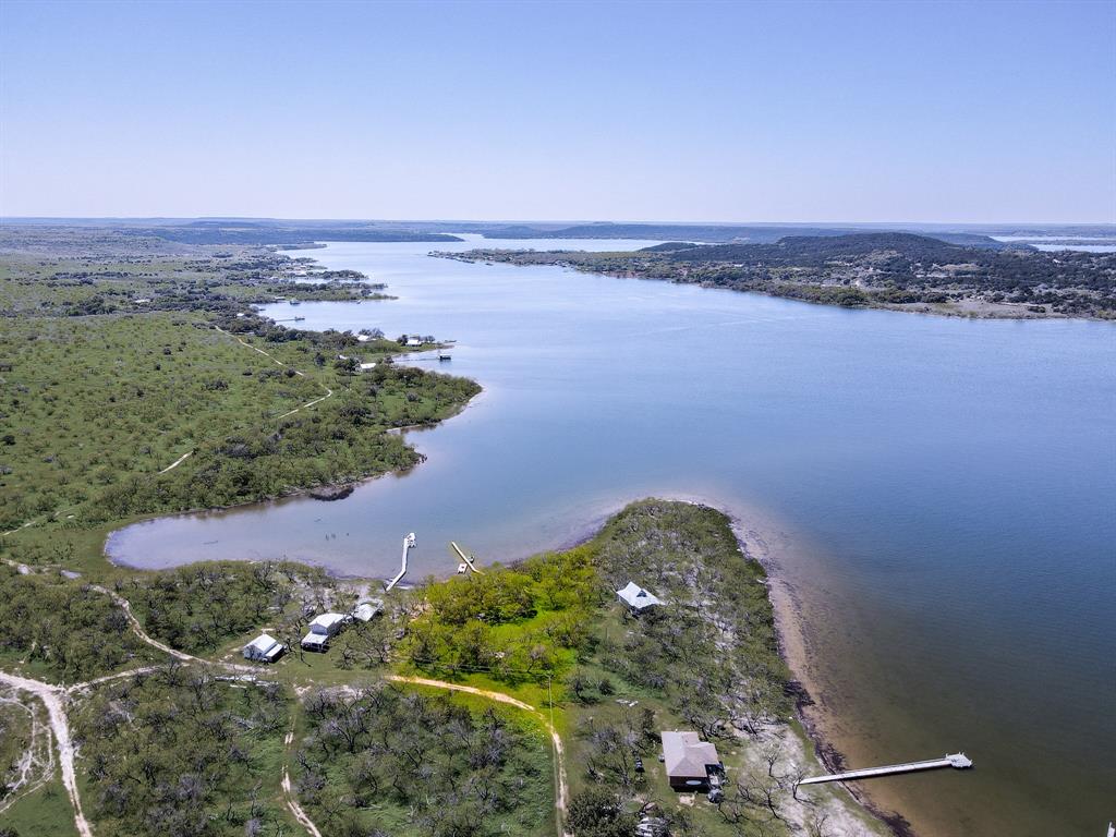 an aerial view of a houses with a lake