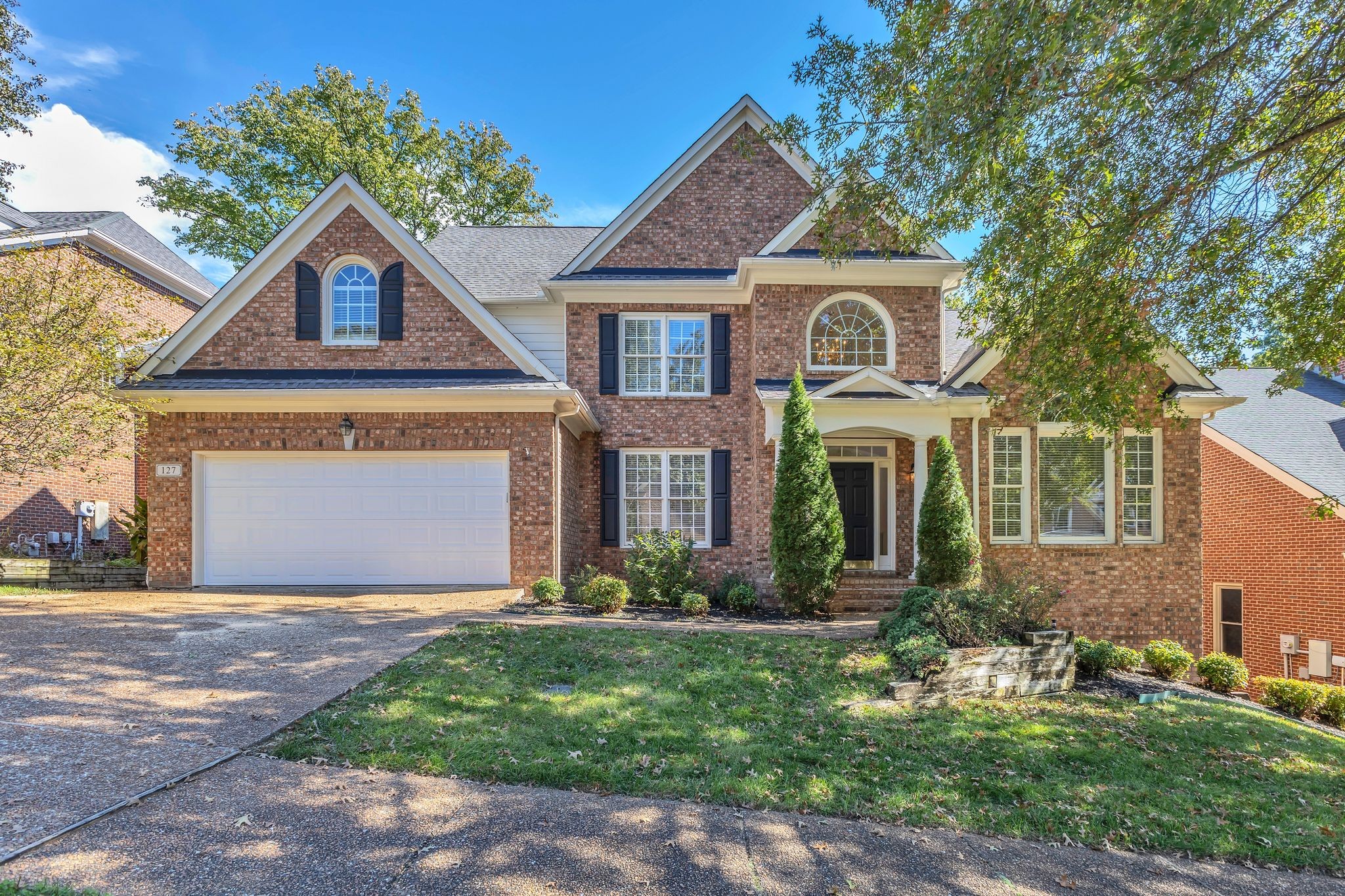 Stately all brick home sits on a  quiet treed lot