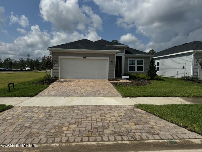 a view of a yard in front view of a house