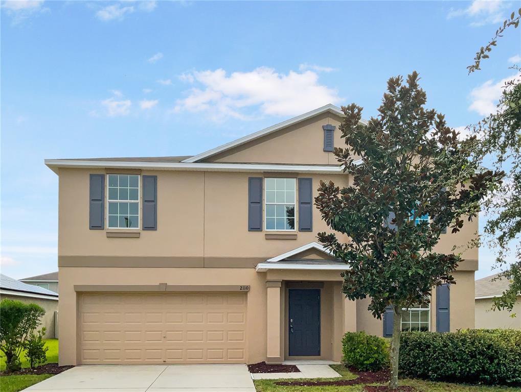 a front view of a house with garage