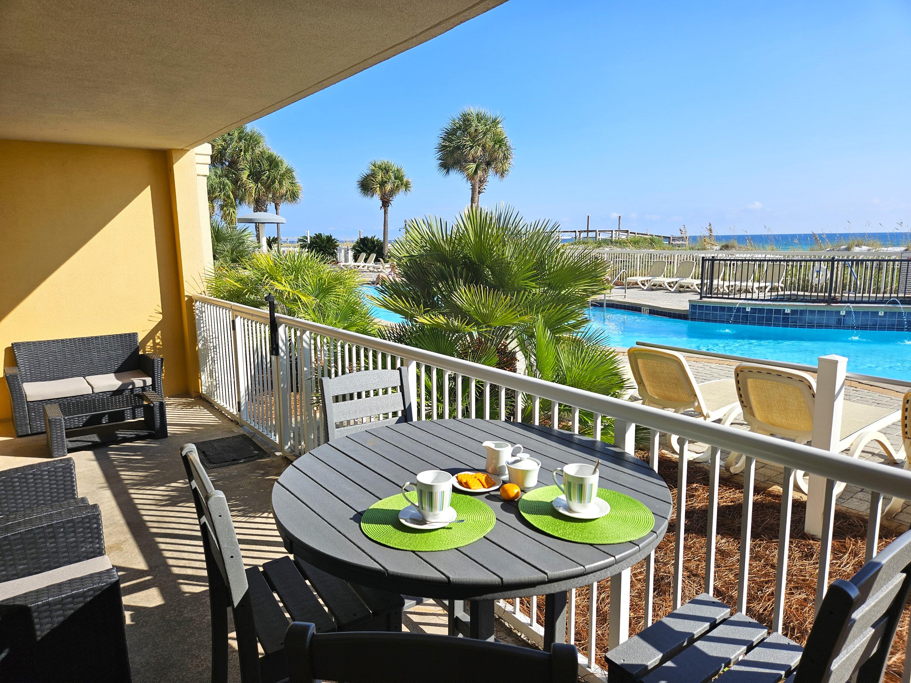 a view of a balcony with chairs and wooden floor