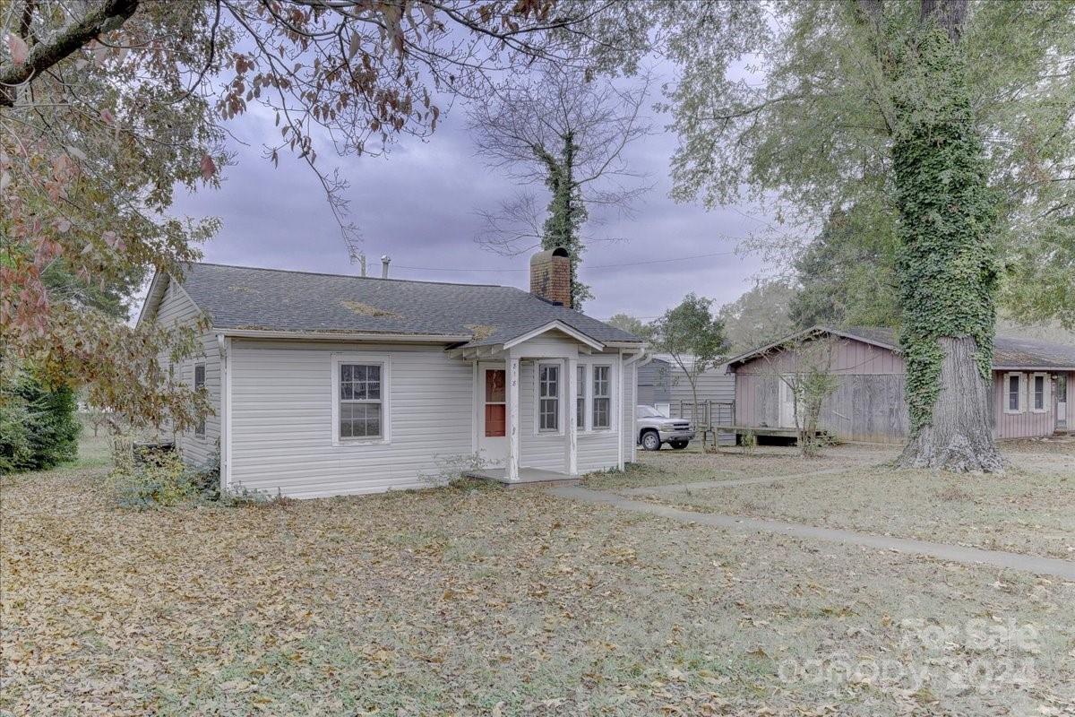 a house that has a tree in front of it