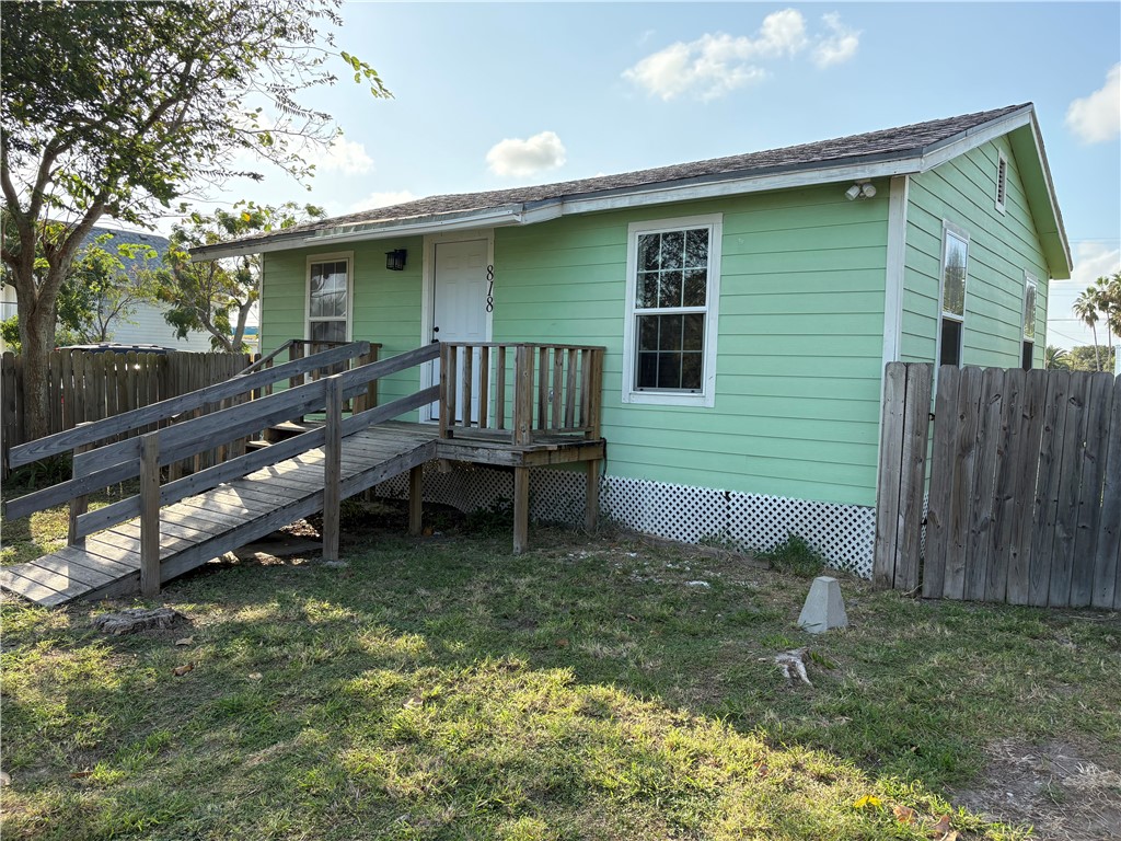 a backyard of a house with table and chairs