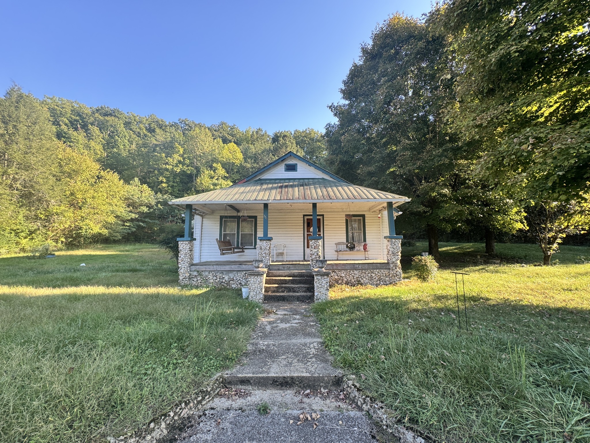 a front view of house with yard and green space