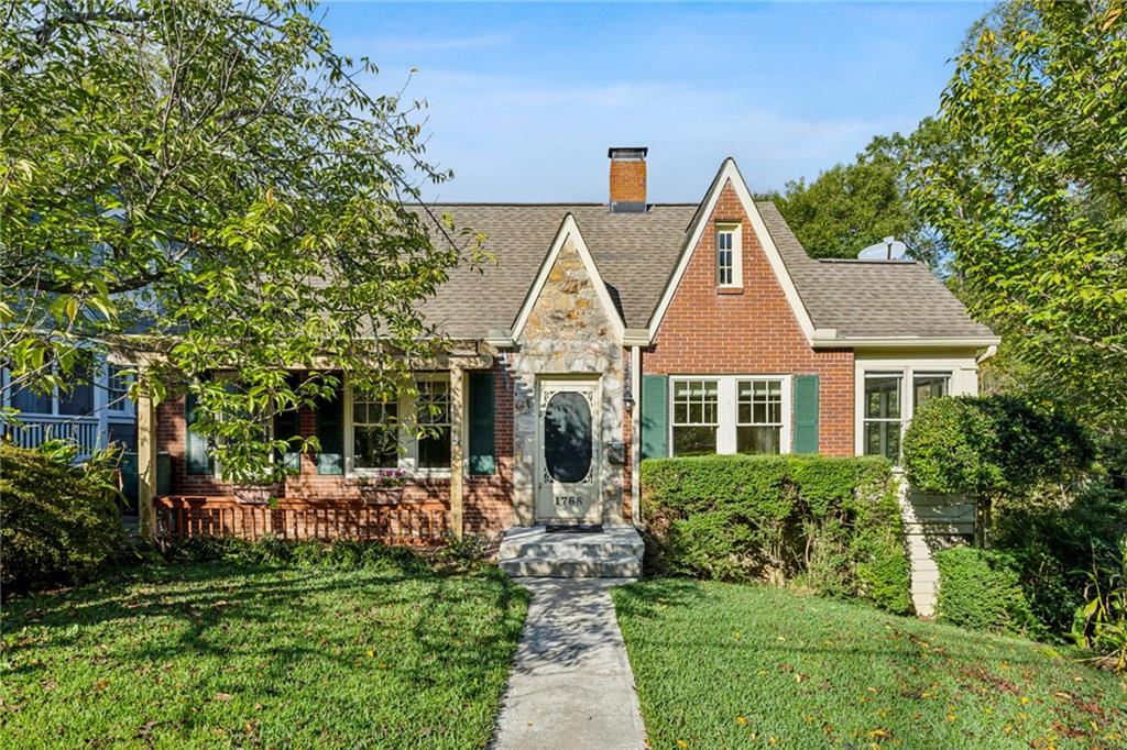 a front view of a house with a yard garden and patio