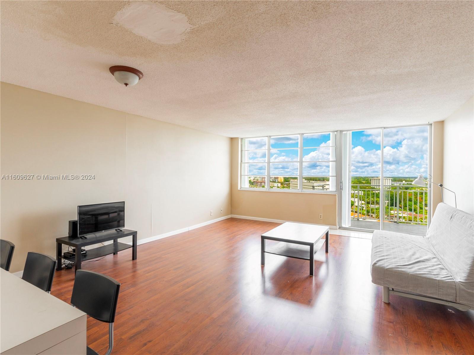 a living room with furniture and a large window