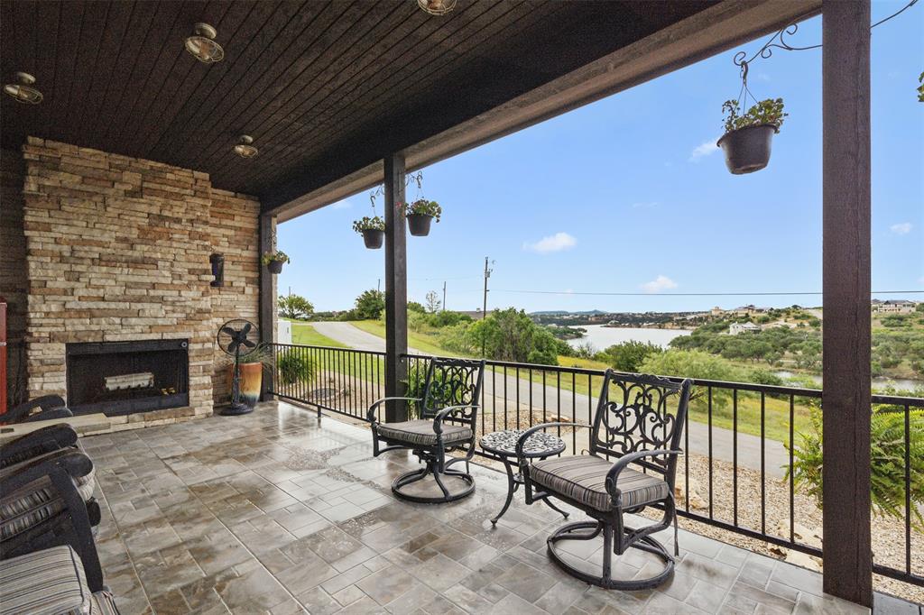 a balcony with furniture and a fireplace