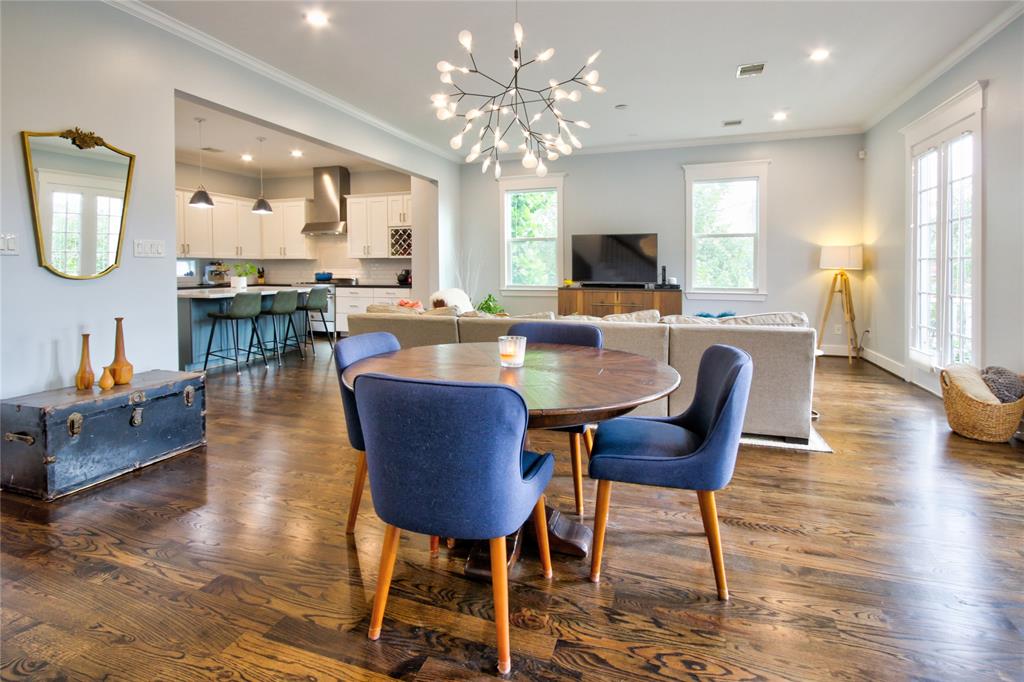 a view of a dining room with furniture a chandelier and wooden floor