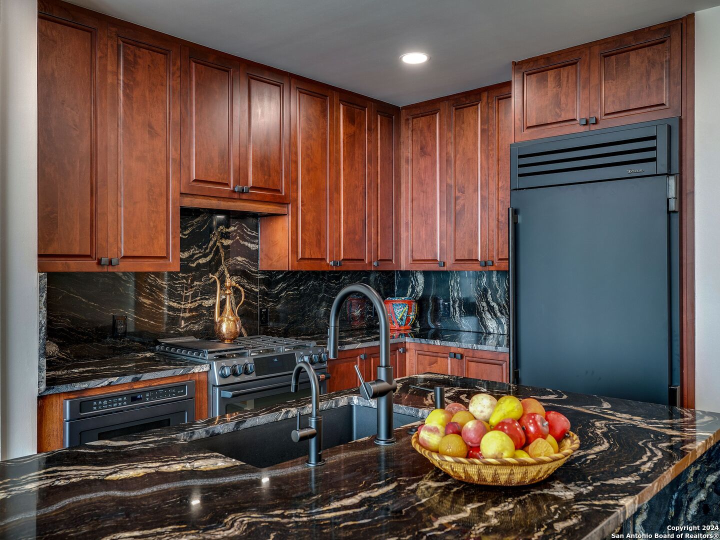 a kitchen with a appliances and cabinets