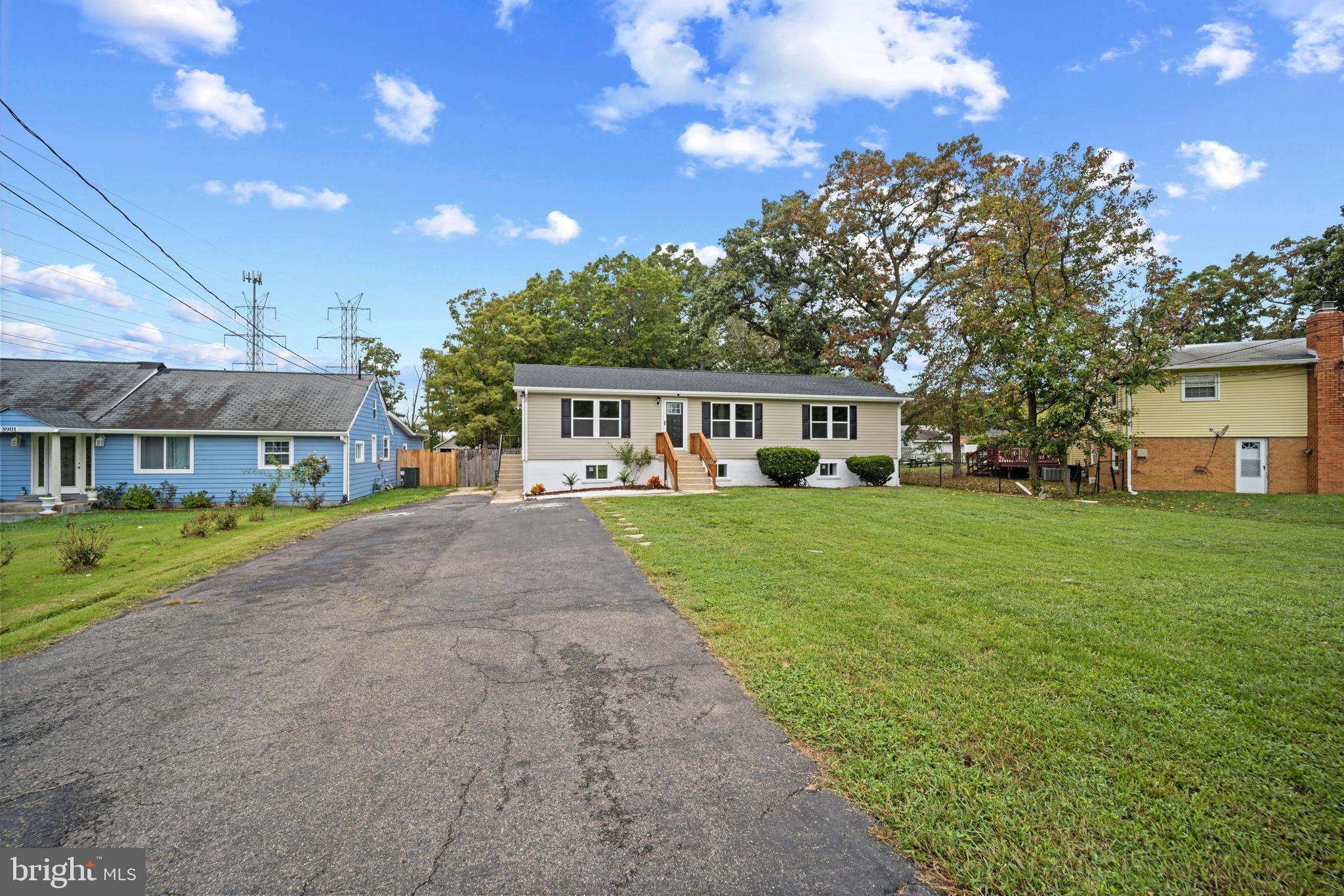 a front view of a house with a yard and potted plants