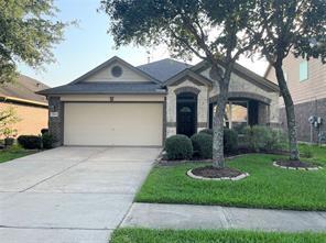 The combination of a well-maintained front yard, a two-car attached garage, and a classic white and brick exterior gives the home an inviting facade.