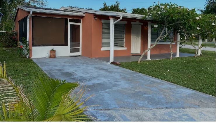 a view of a house with a yard and tree