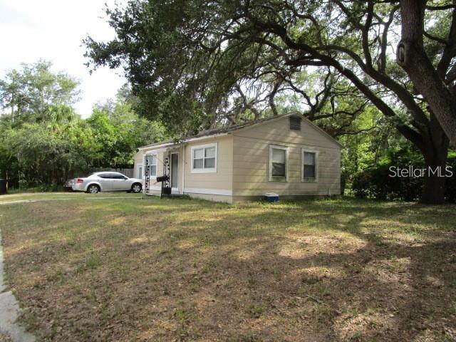 a front view of house with yard and green space