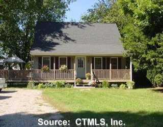 a view of house with backyard and front door