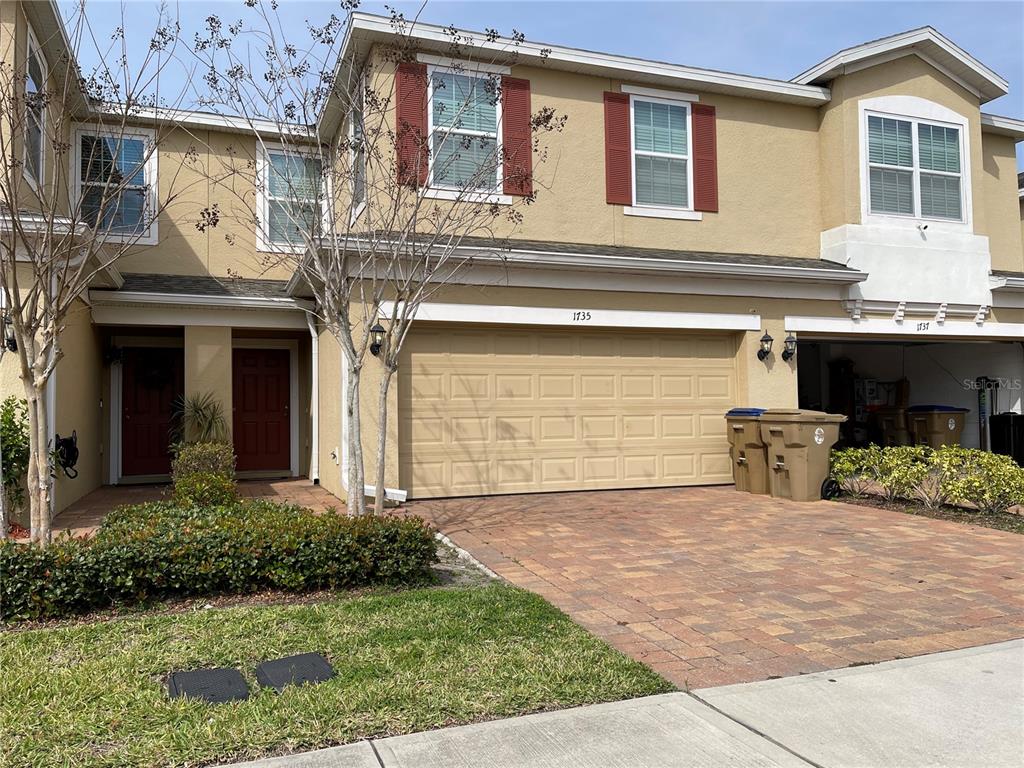 a front view of a house with a yard and garage