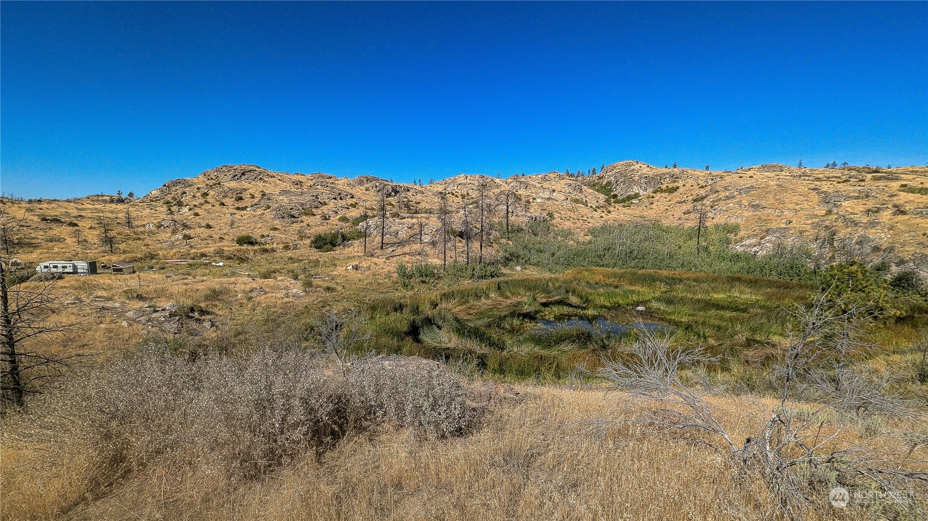 a view of a large mountain with mountains in the background