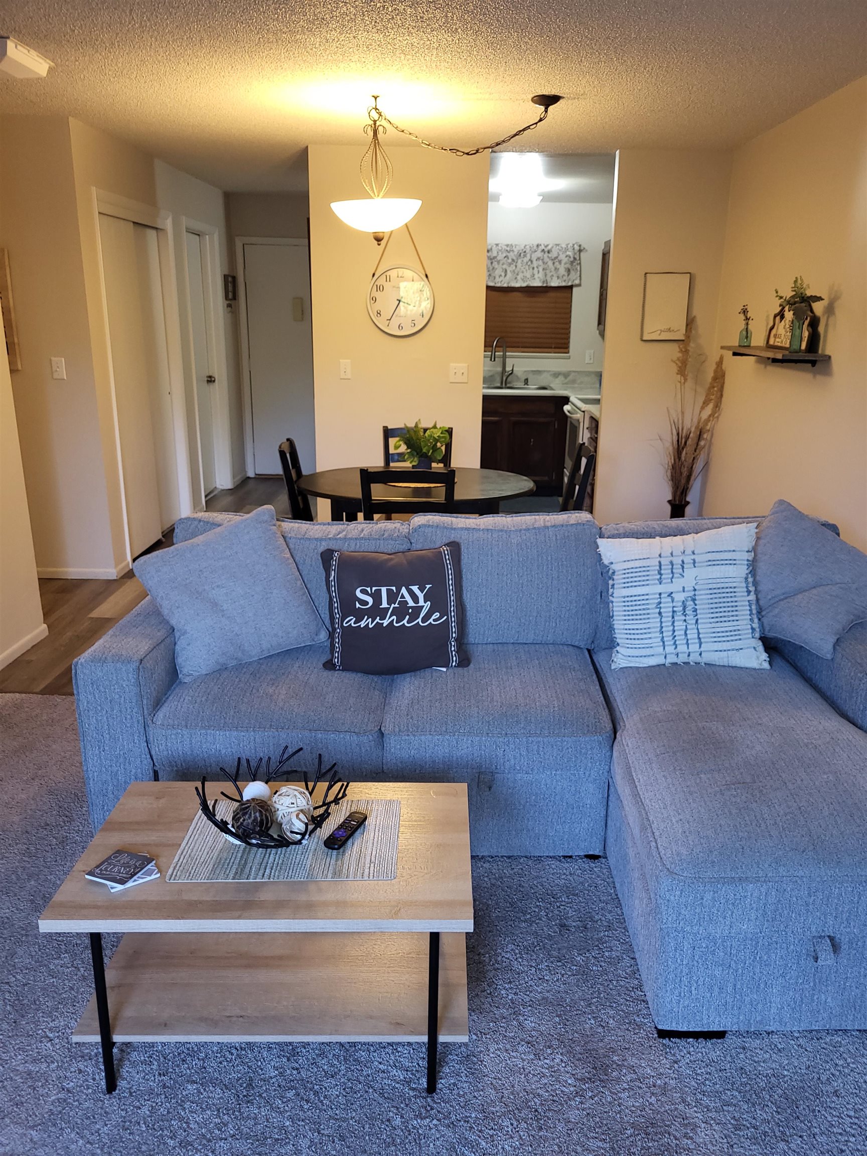 a living room with furniture and a fireplace