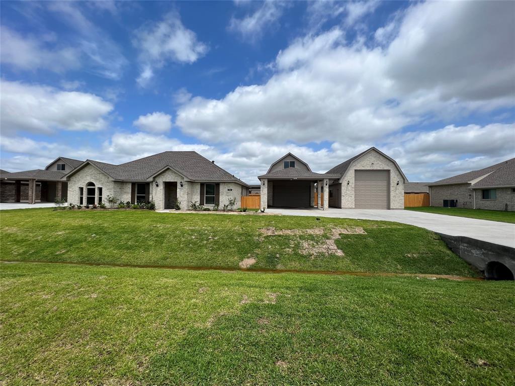 a front view of house with yard and green space