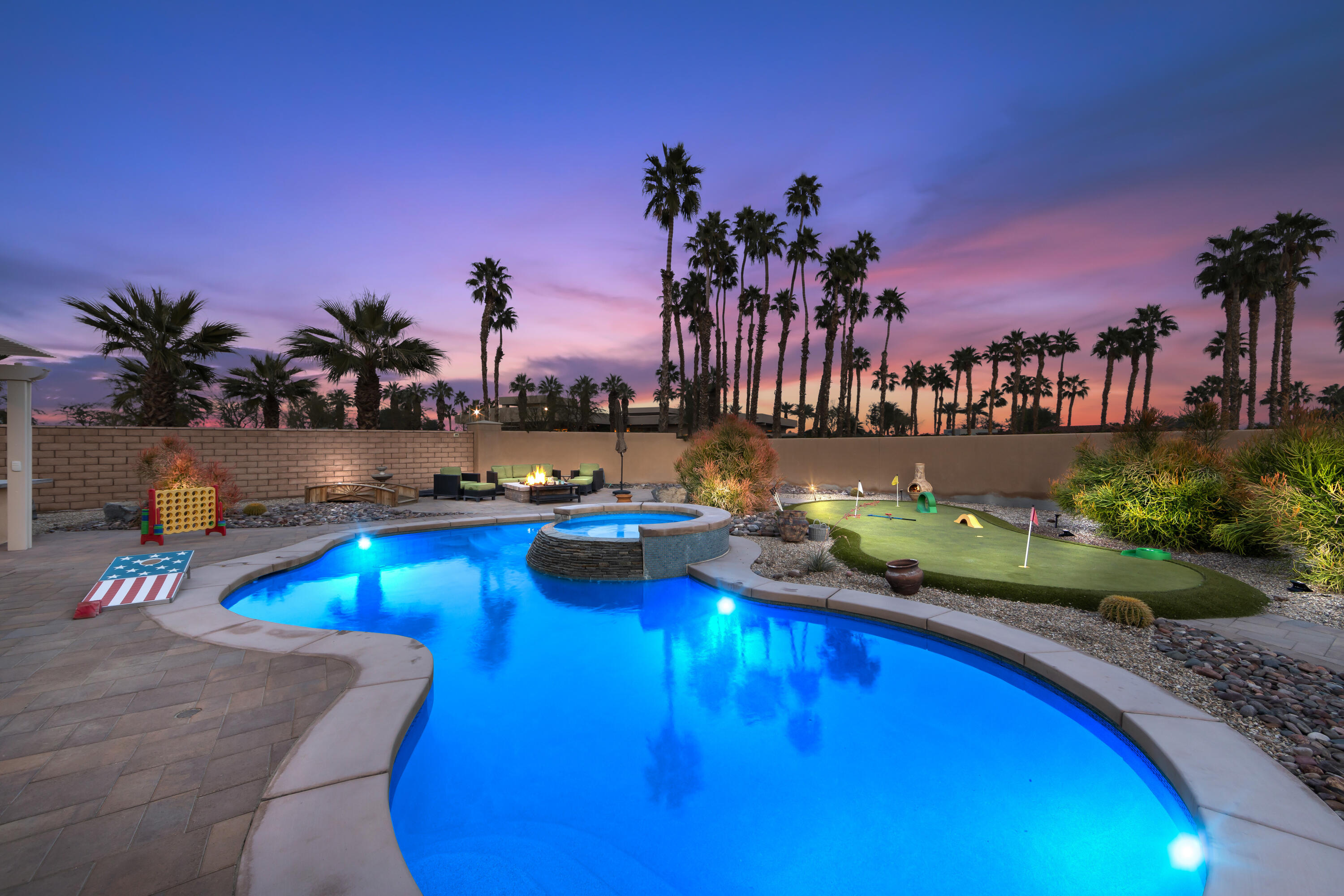 a view of a swimming pool with an outdoor seating and a potted plants