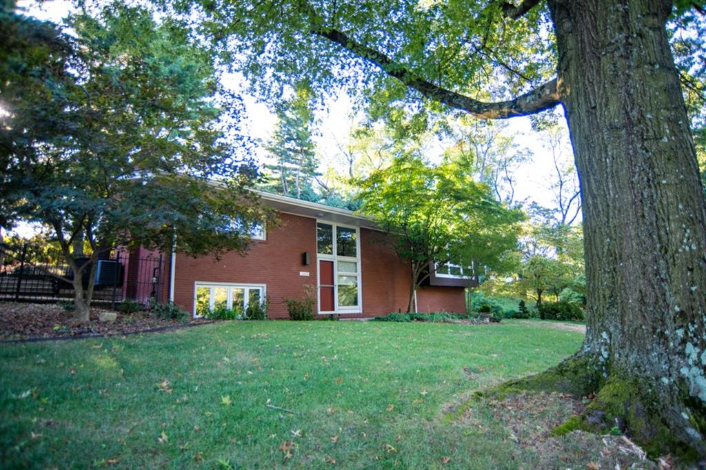 a front view of house with yard and green space