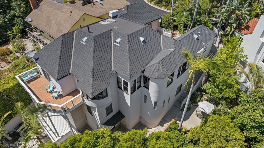 an aerial view of a house with outdoor space and sitting area