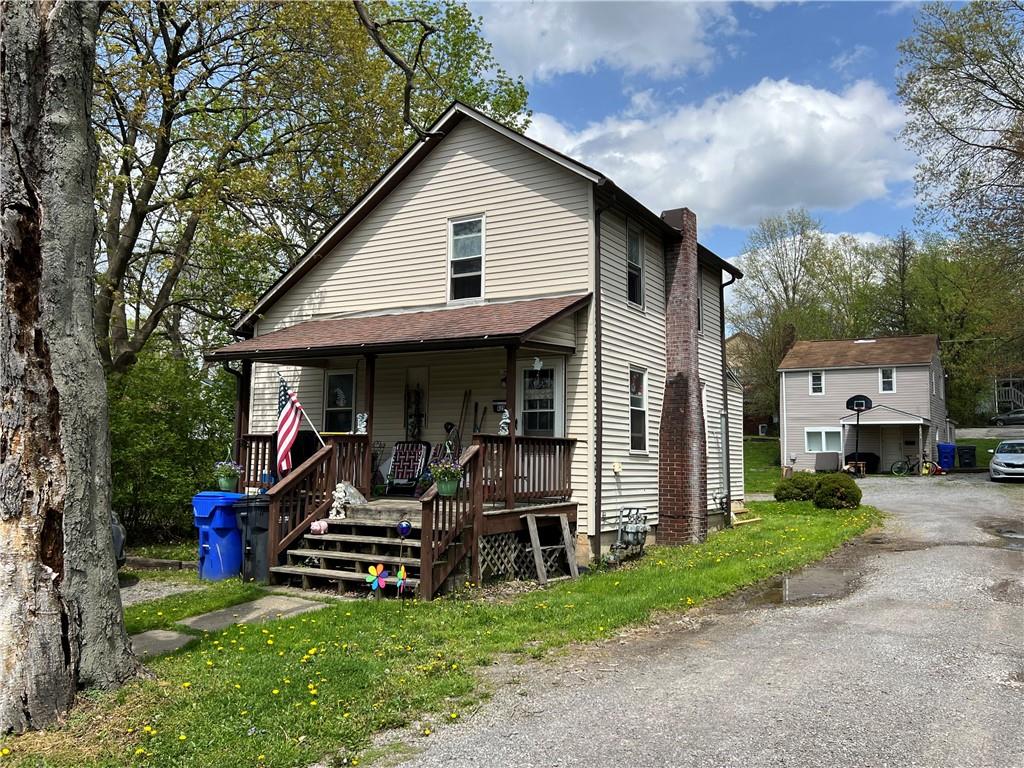 a view of a house with a patio and a yard