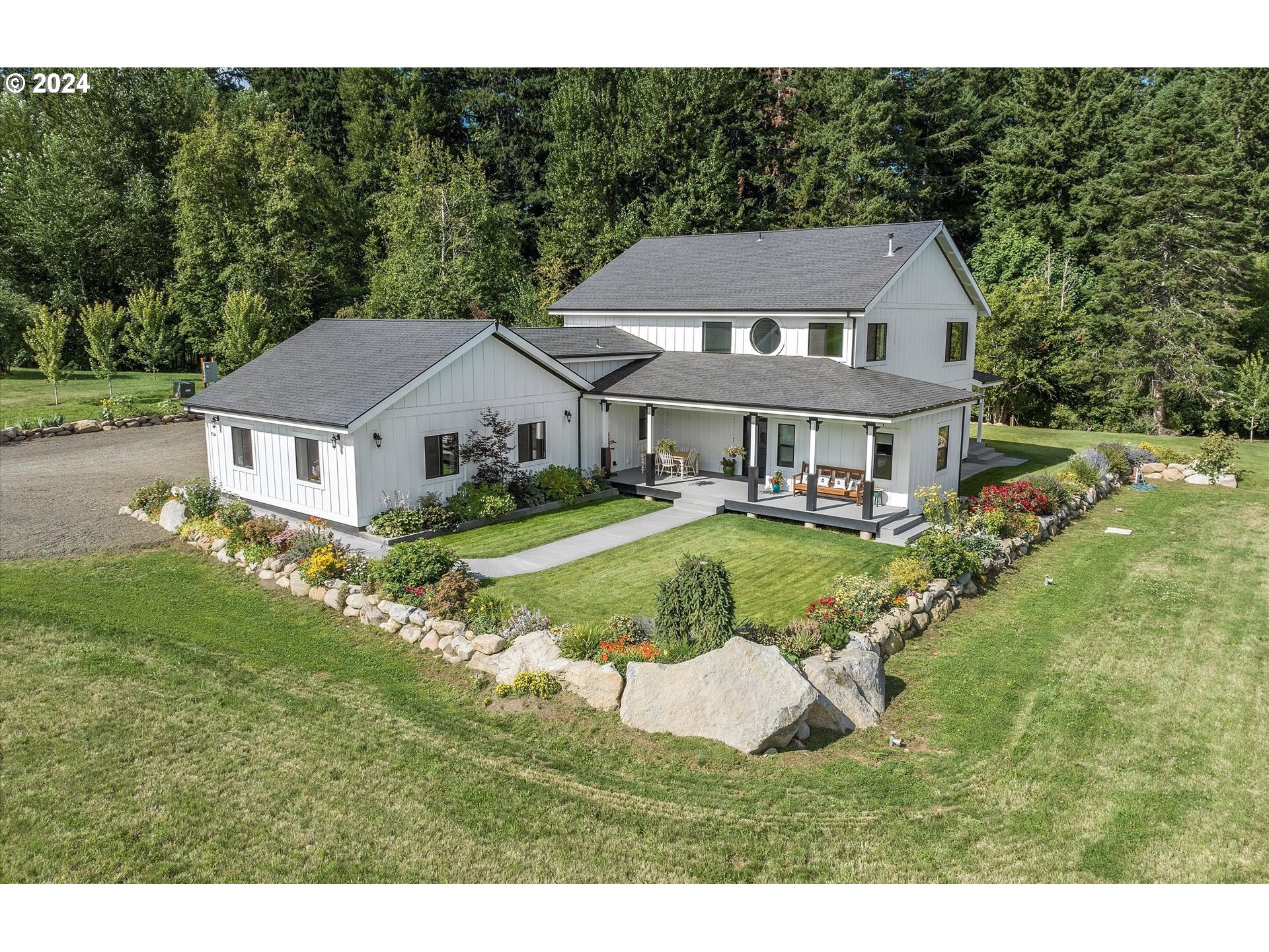 a aerial view of a house with a yard table and chairs