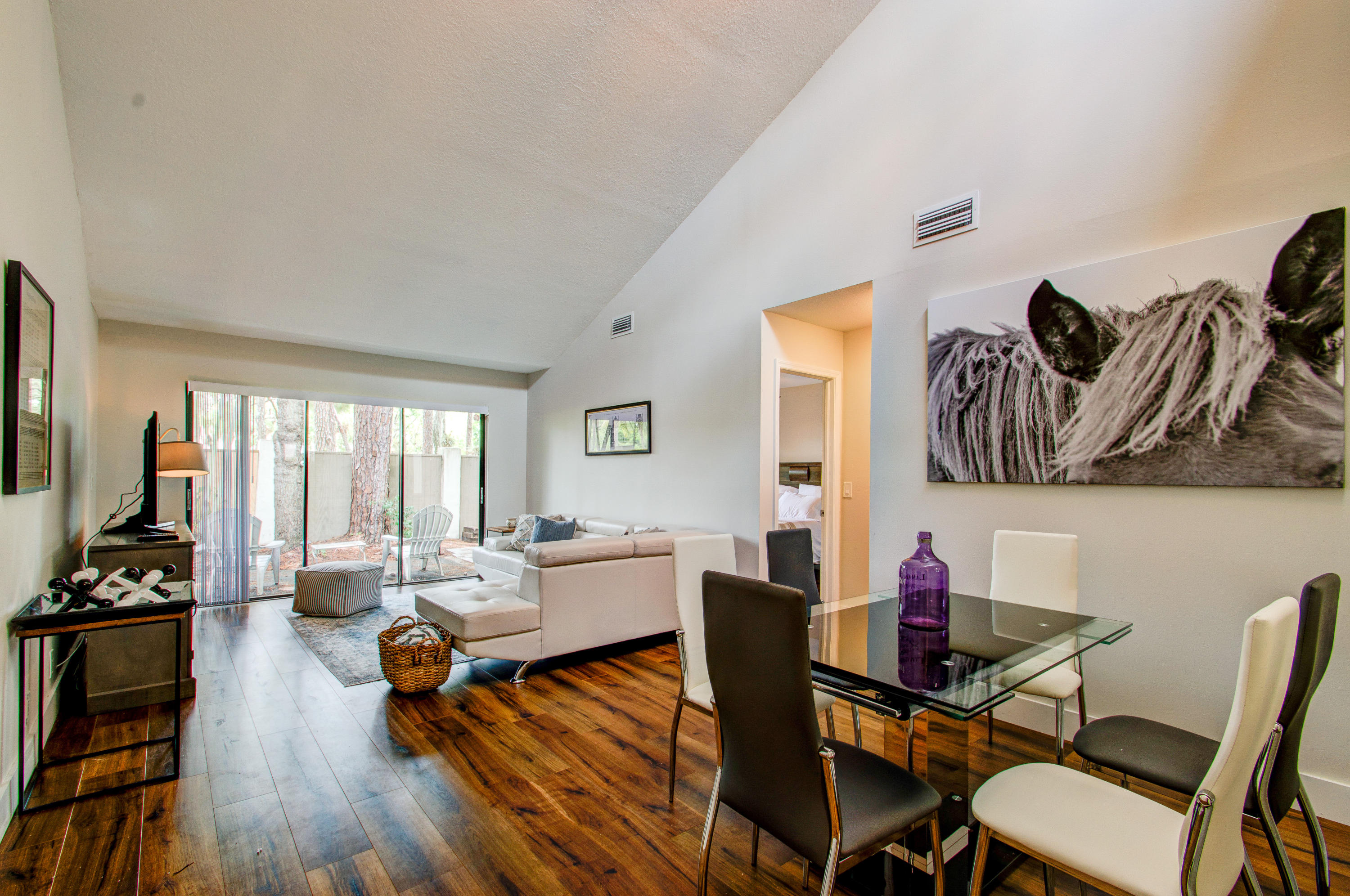 a living room with furniture dining area and wooden floor