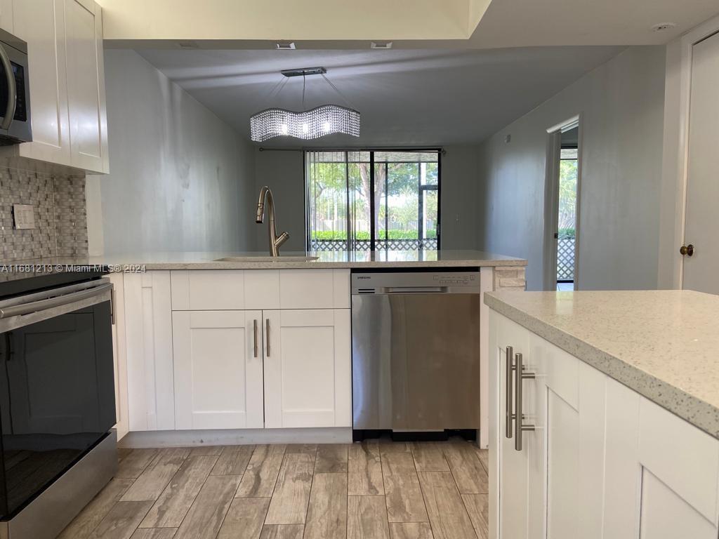 a view of a kitchen counter space and wooden floor