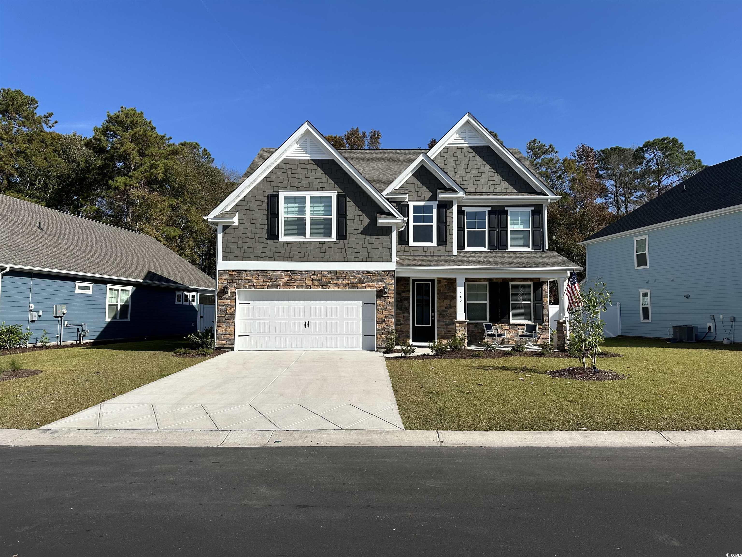 Craftsman inspired home featuring a front yard, ce