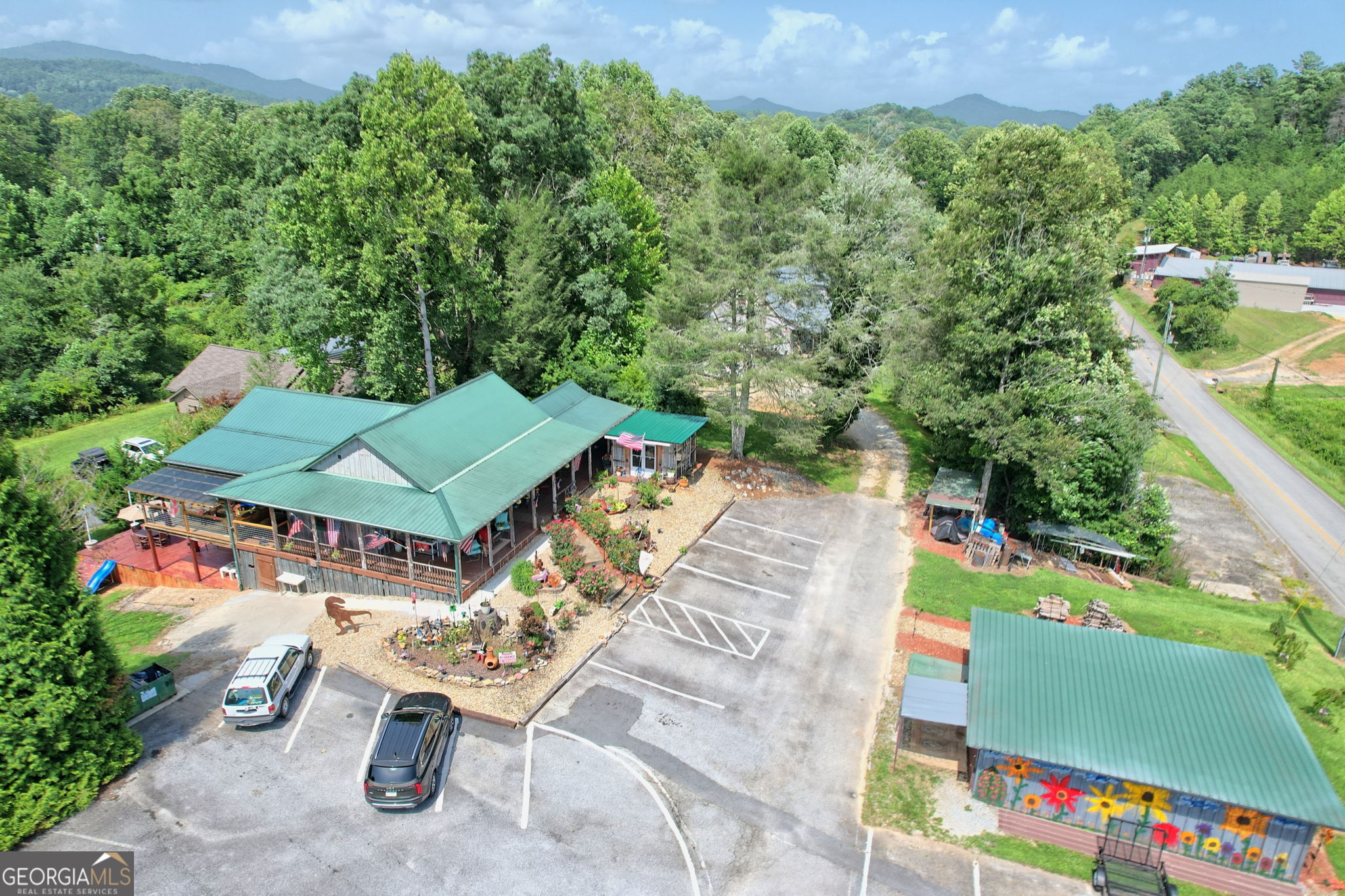 an aerial view of a house with a garden and a yard