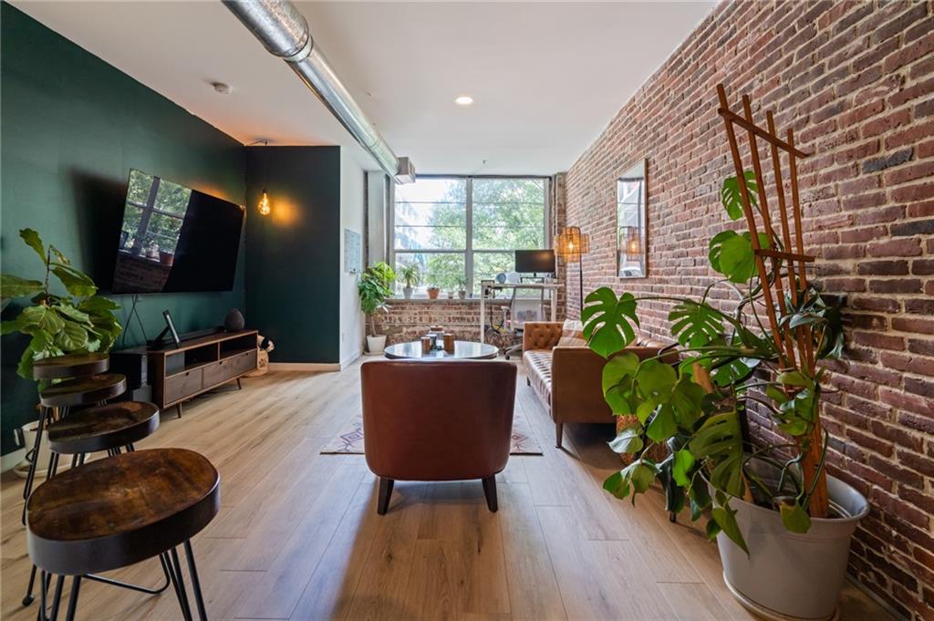 a living room with furniture and a potted plant