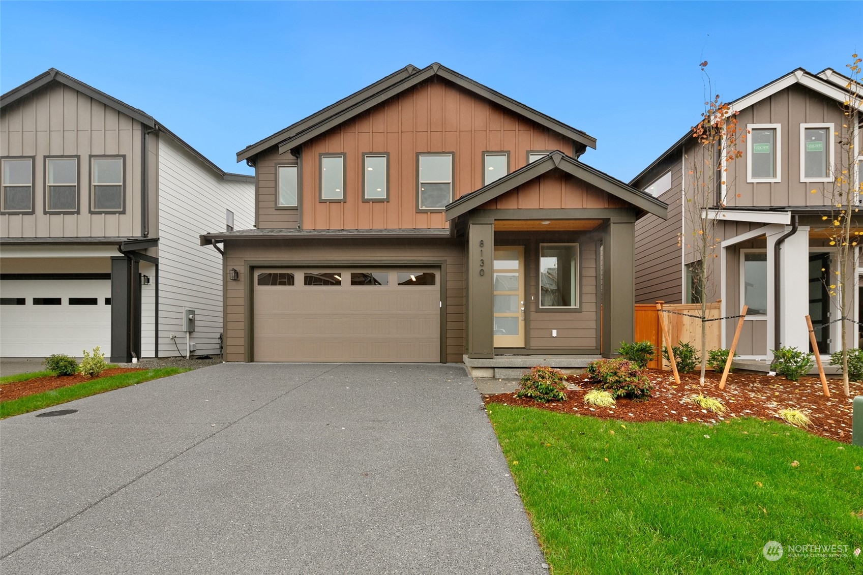 a front view of a house with a yard and garage