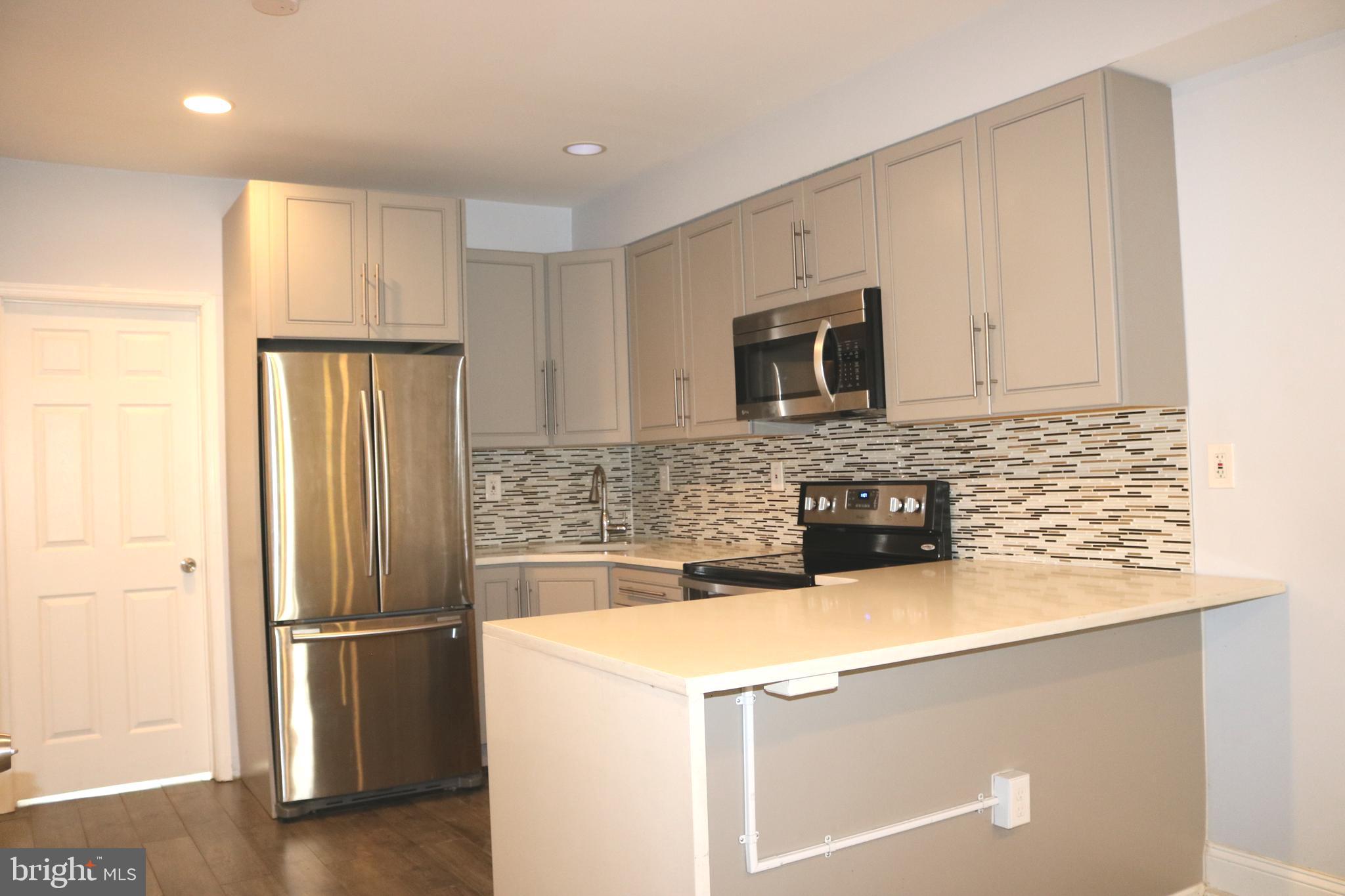 a kitchen with a refrigerator sink and microwave