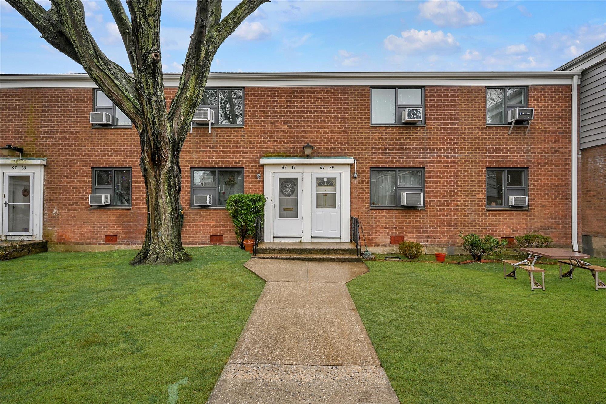 View of front of house featuring a front lawn and cooling unit