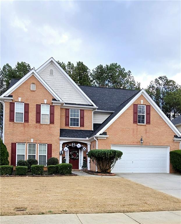 a front view of a house with a yard