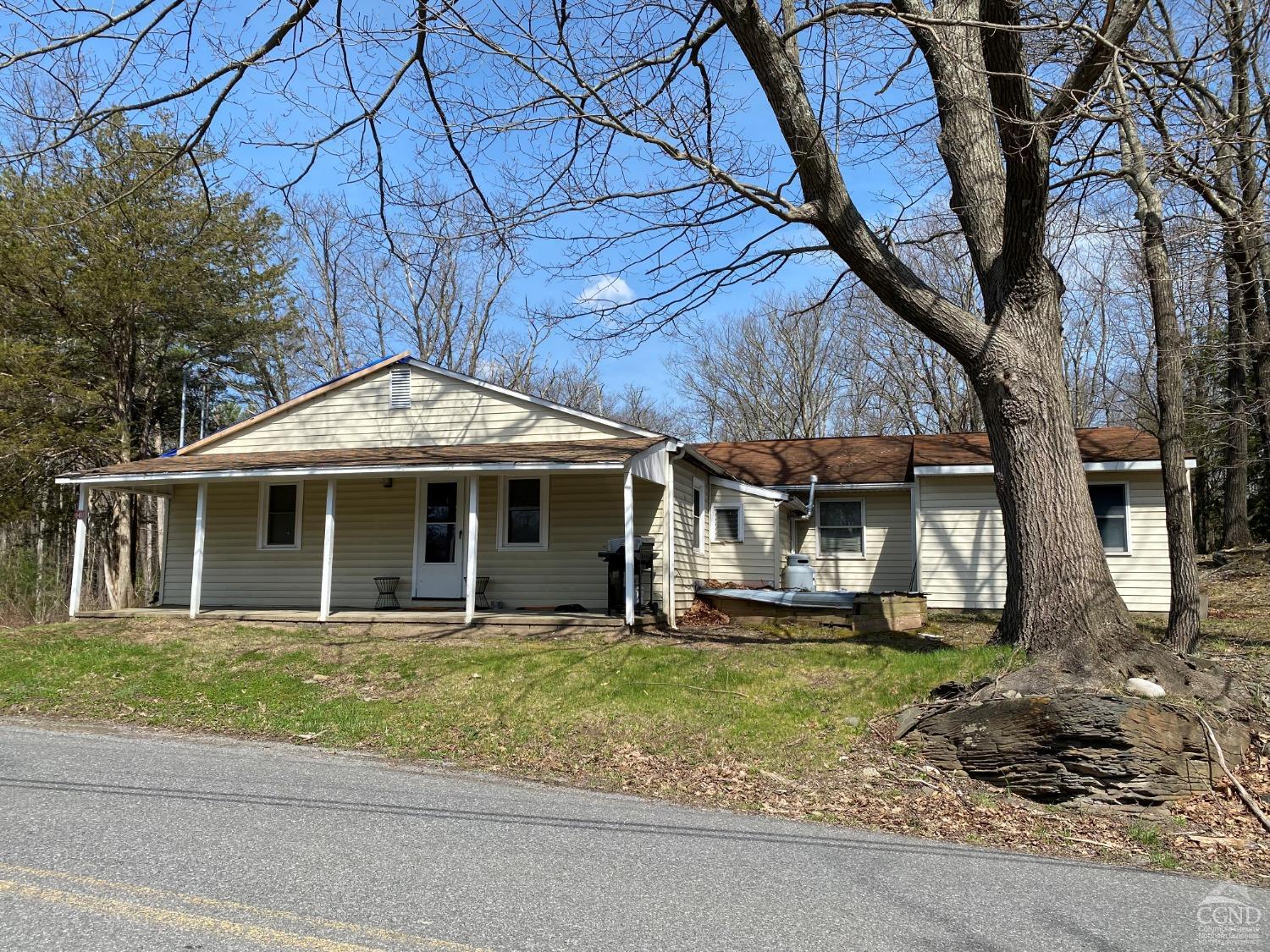 a front view of a house with a garden