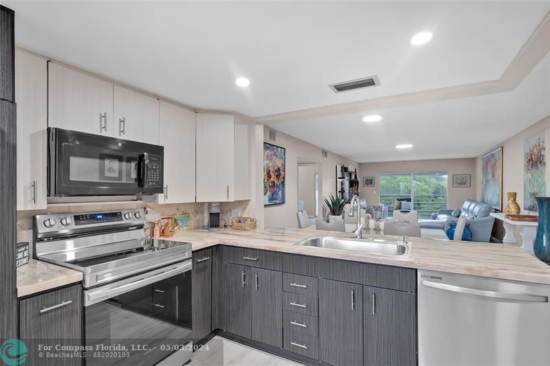 a kitchen with a sink stove and cabinets