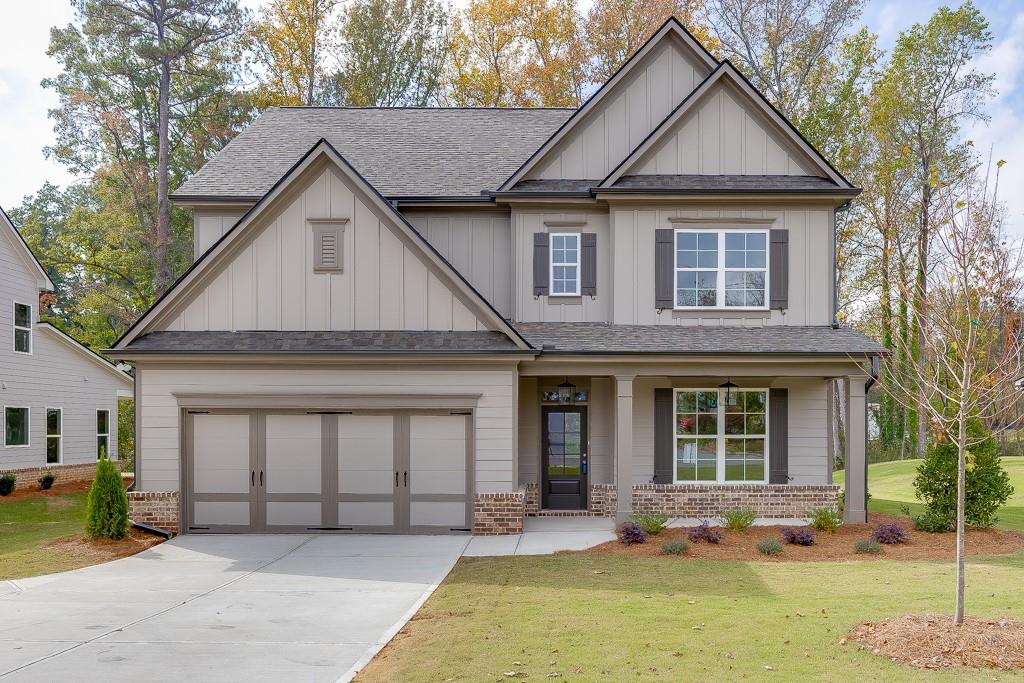 a front view of a house with a yard and garage