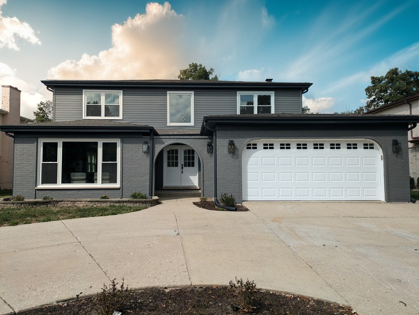 a front view of a house with a yard and garage