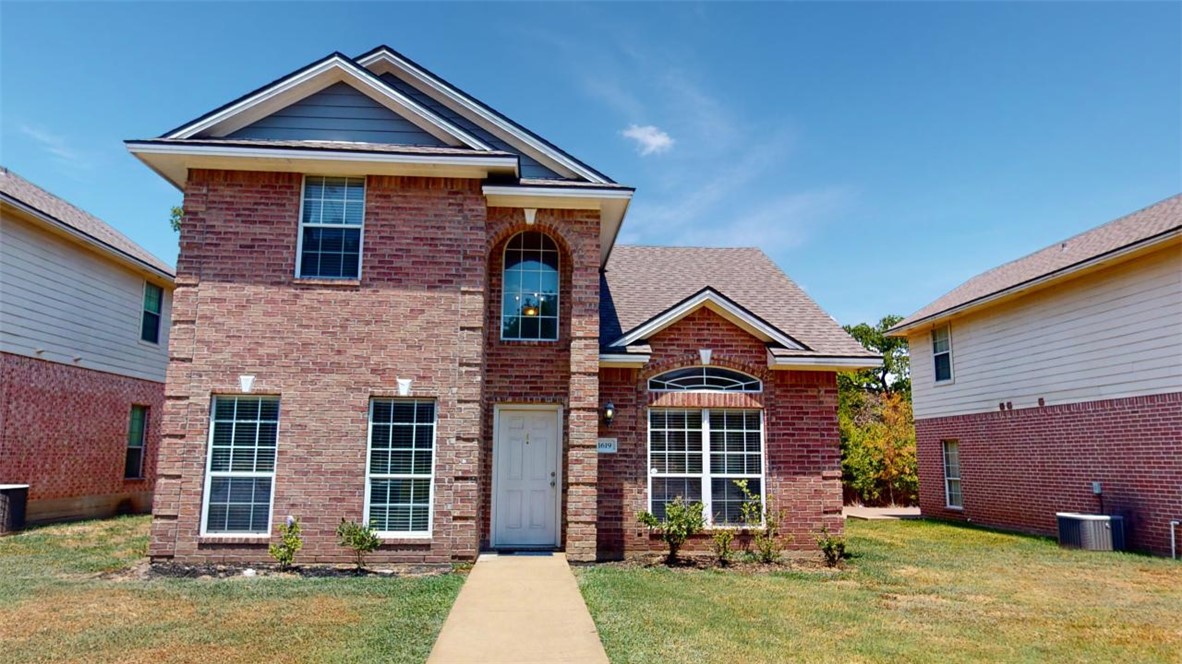 front view of a house with a yard