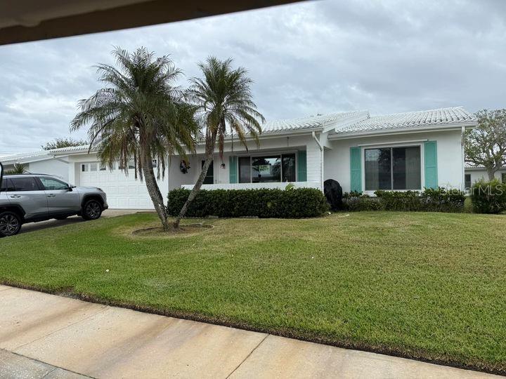 a front view of house with yard and green space