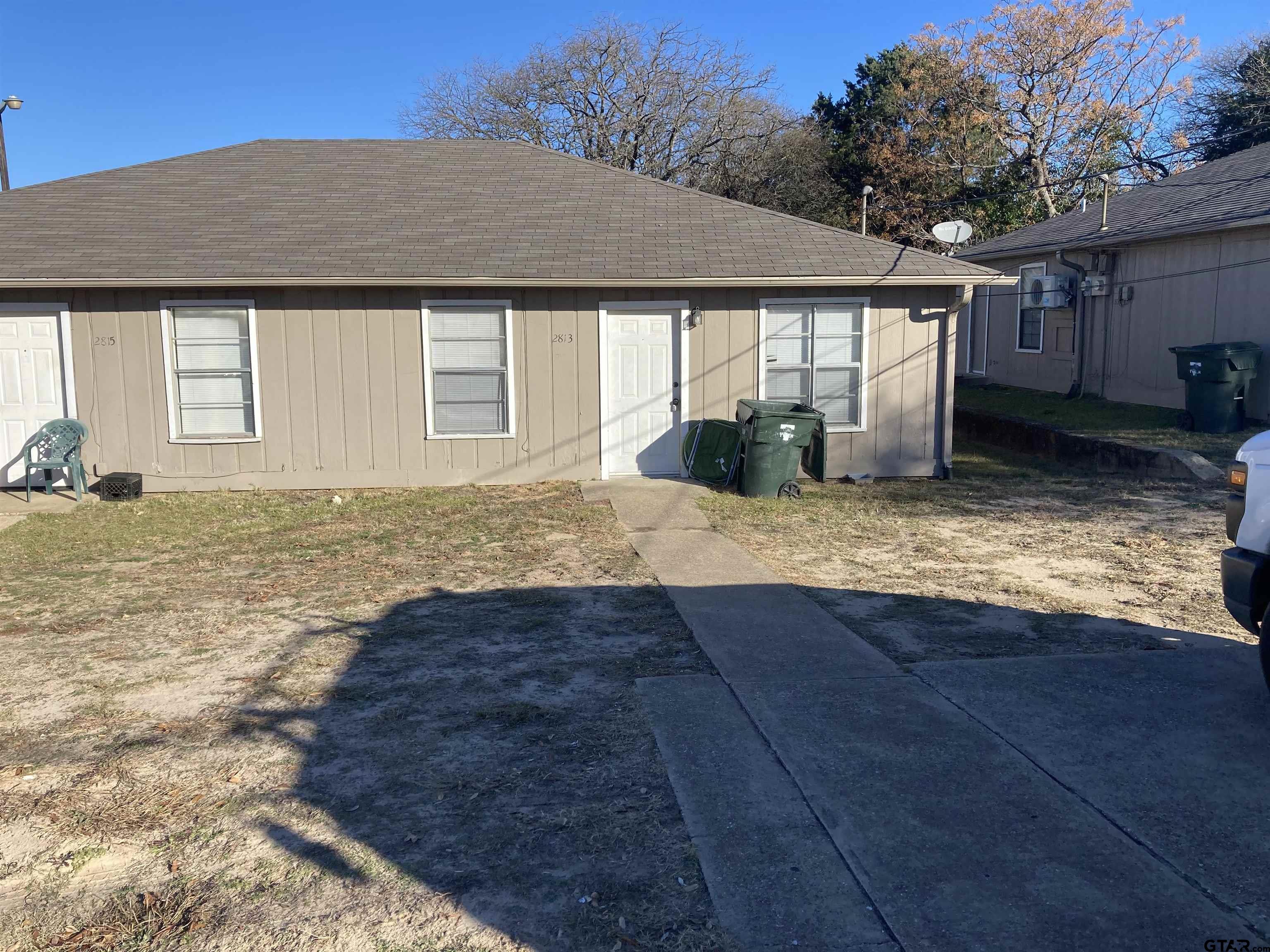 a view of a house with backyard and sitting area