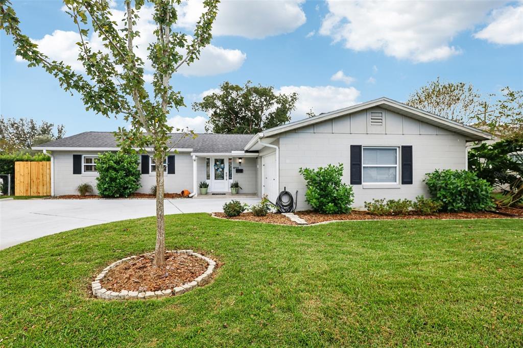 a view of a house with a backyard