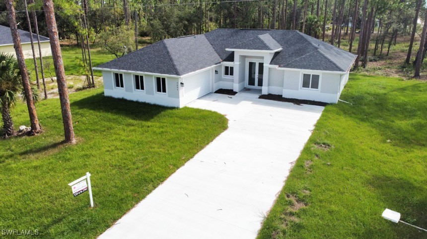 a aerial view of a house with a yard table and chairs