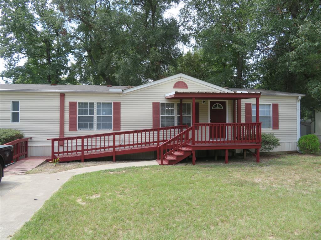 a front view of a house with a garden and deck