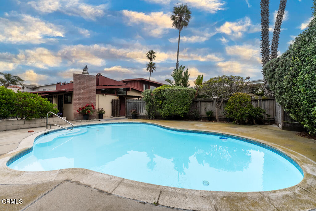 a view of a swimming pool with a yard